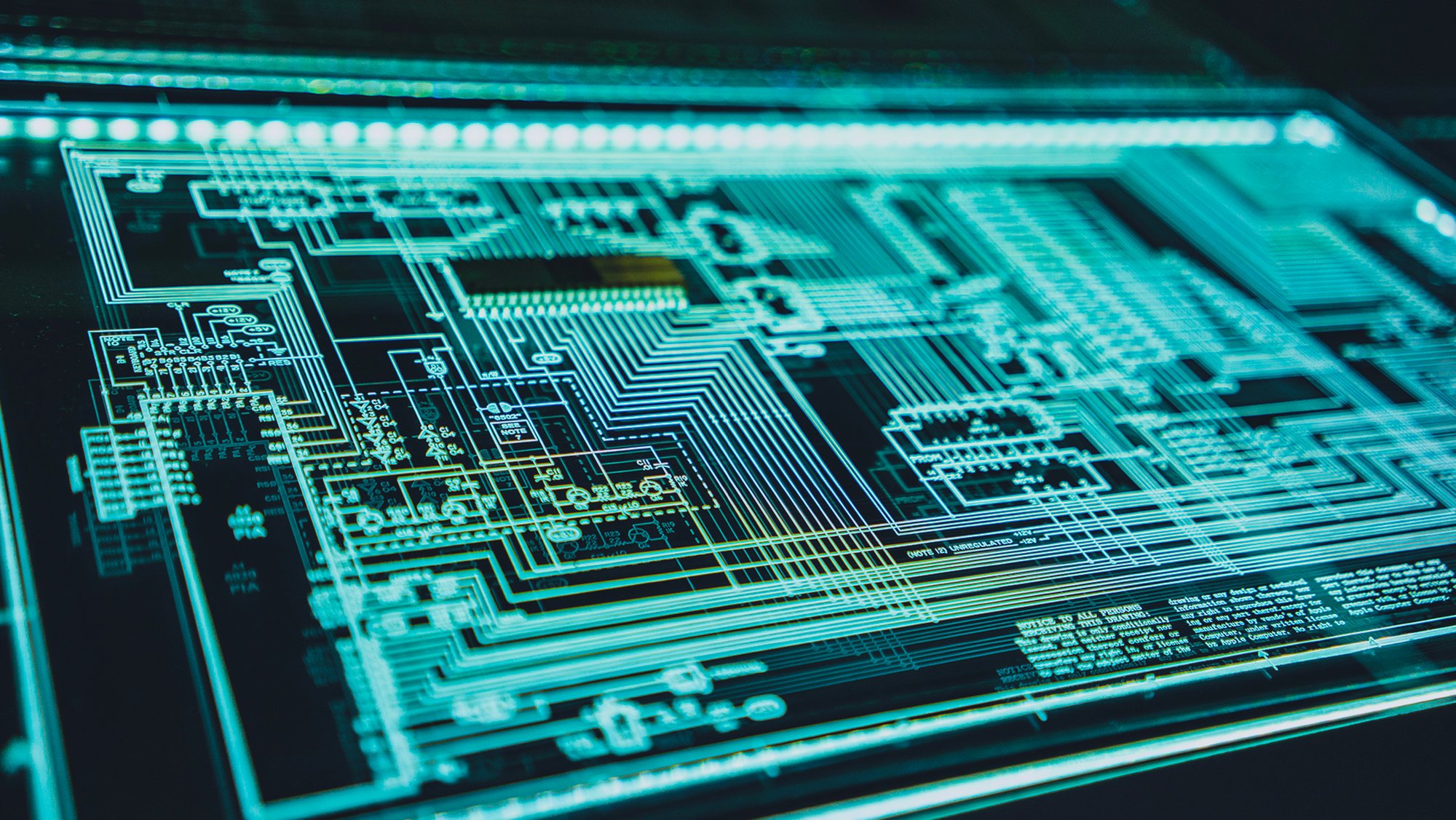 Glowing turquoise electronic circuit diagram on a dark background, evoking cybersecurity