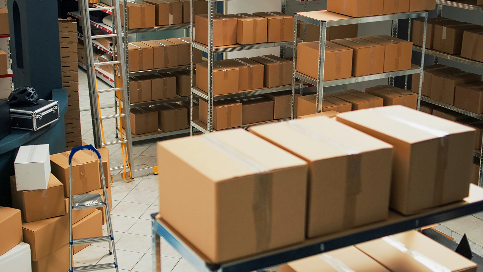 Cardboard boxes on metal shelving in a warehouse