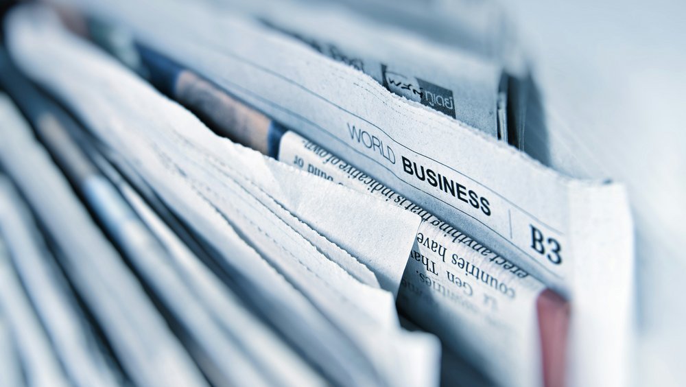 Close-up of a stack of newspapers, with the “World Business” section visible on one